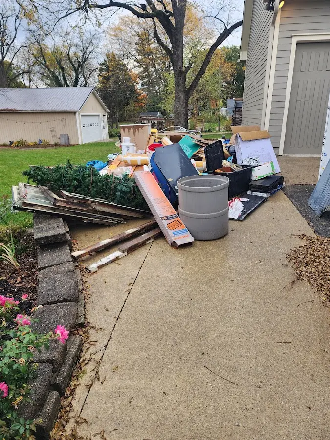 Dumpster being loaded with debris for 12 Yard Dumpster Rental in Elberton